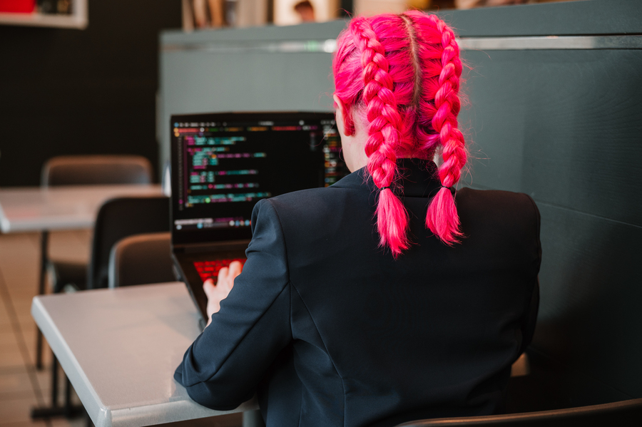 Sviluppatrice web al lavoro su codice, simbolo di attenzione a qualità e accessibilità